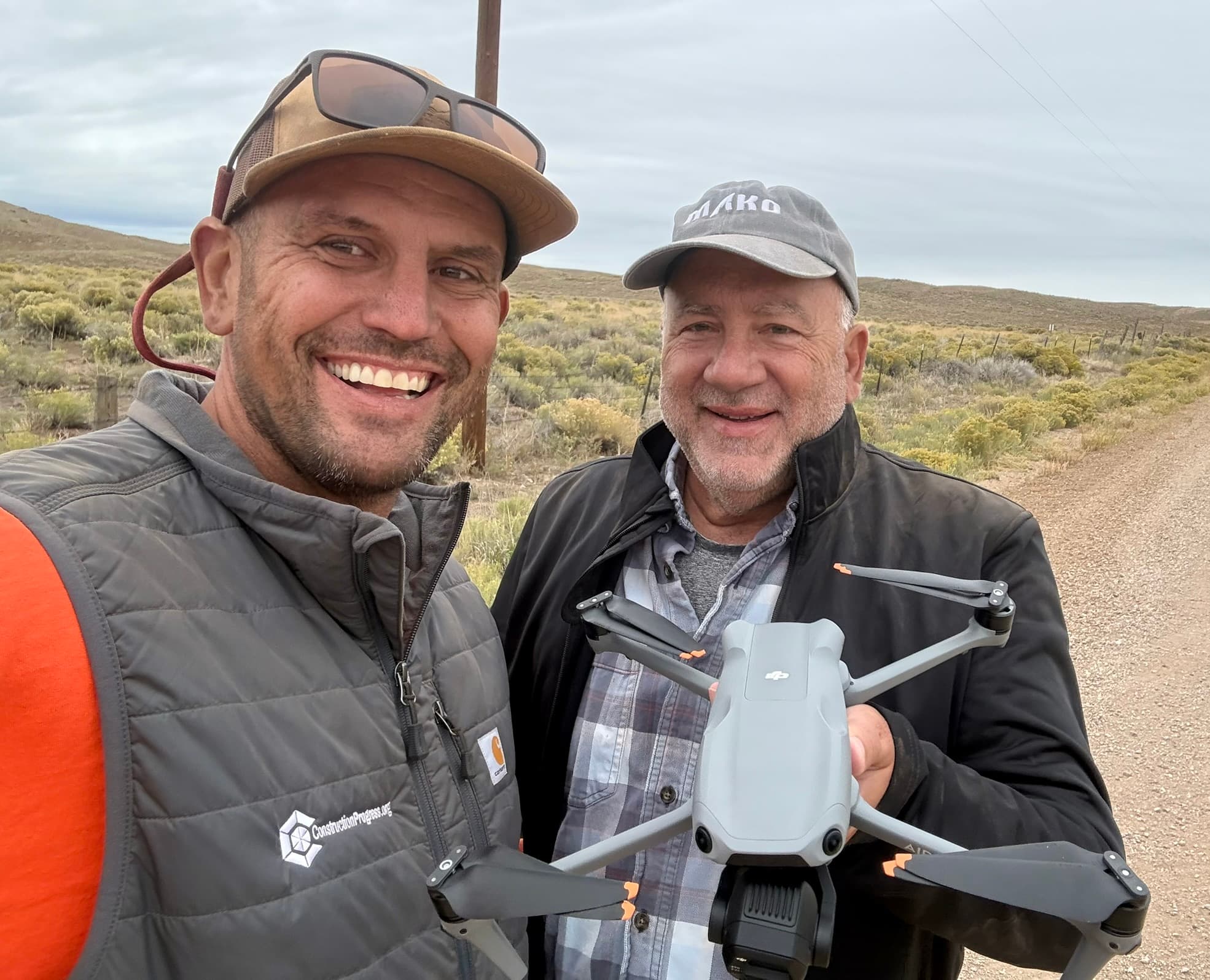 Devon Tilly and Angelo Tenaglia on a site visit, Angelo holding his drone