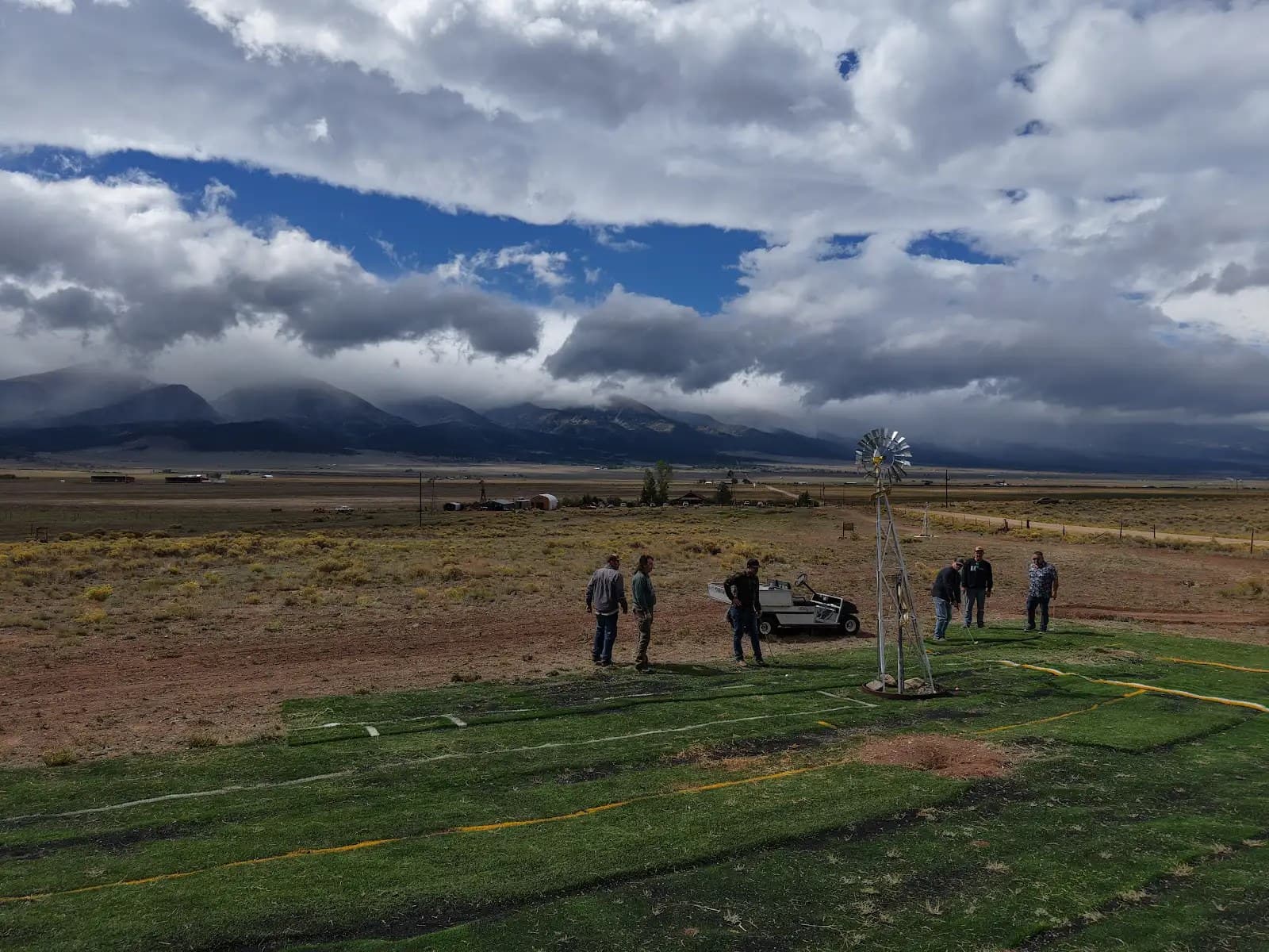 MVWD + ITS + Andersen retreat group at the Turkey Toe windmill with the Sangre de Cristo range behind them