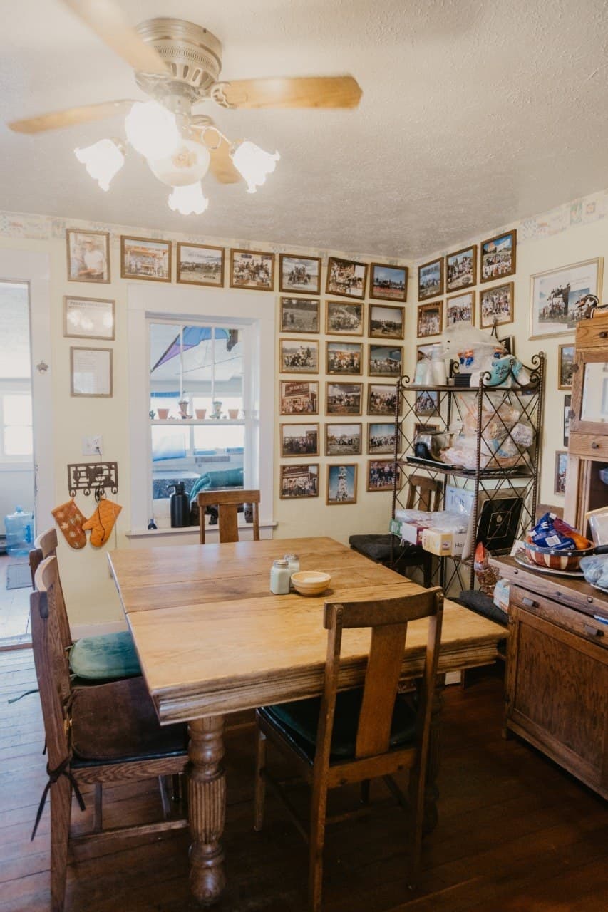The Dad's Day kitchen wall โ 40+ years of framed group photos added one every year