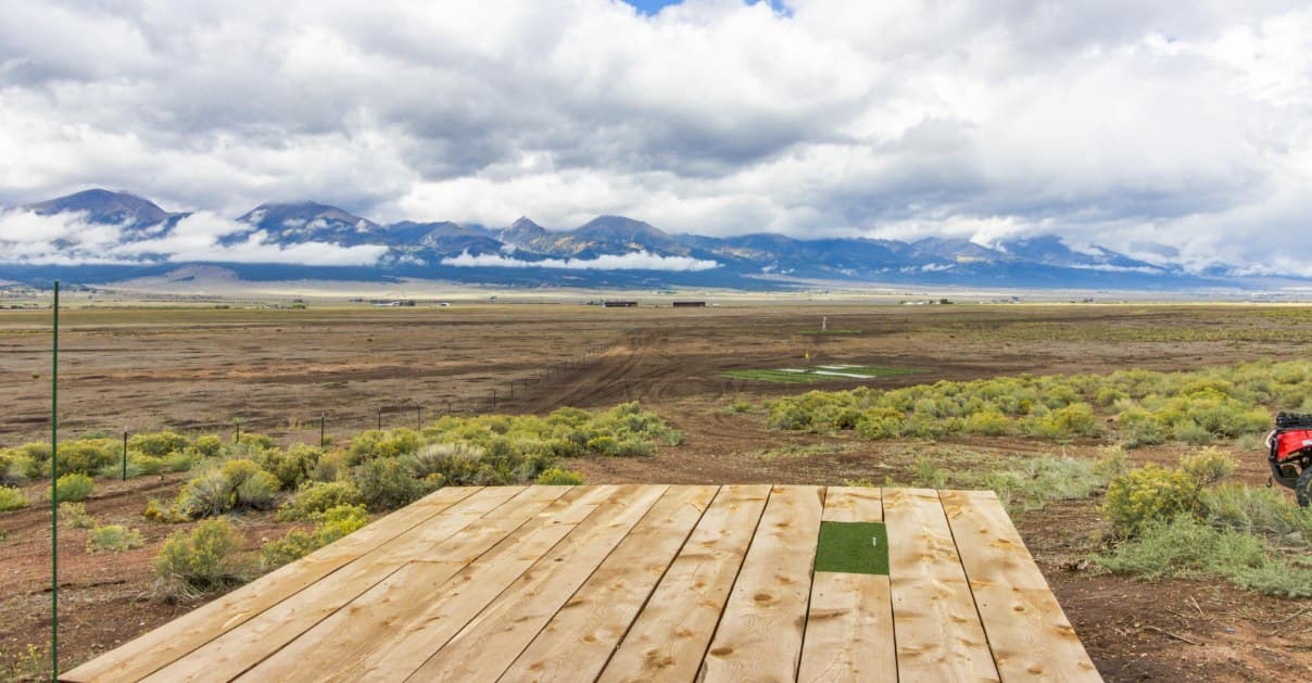 View from the tee box at the Summit — the signature hole — overlooking the Wet Mountain Valley and Sangre de Cristo range