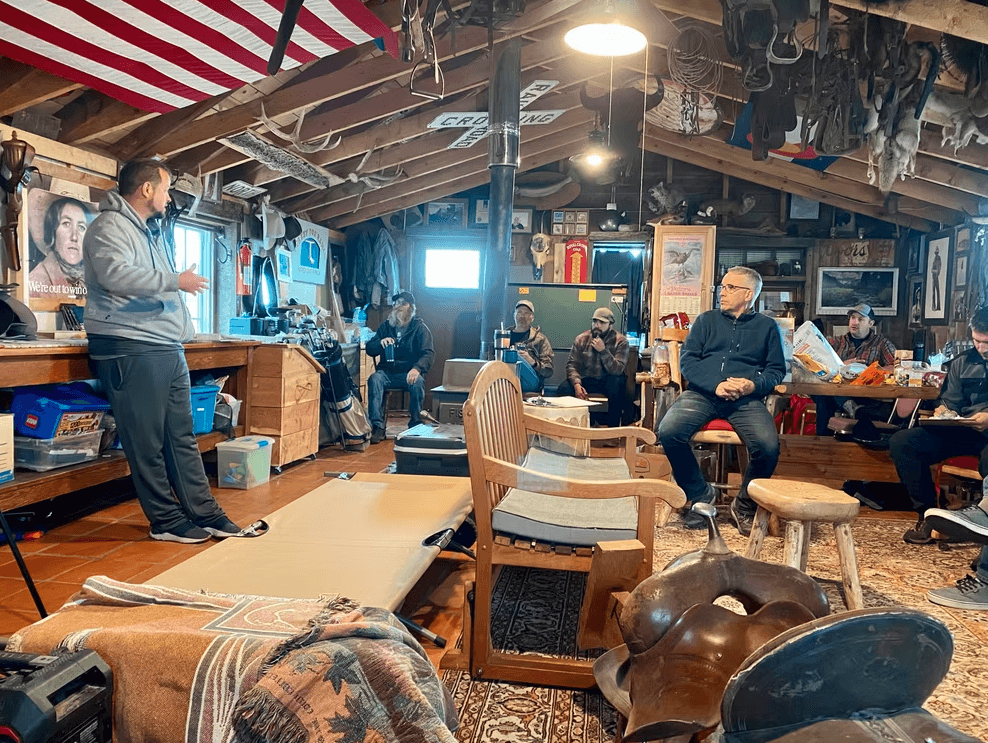 Guests using Eva's Bunk House as a rustic gathering space for conversation and group time