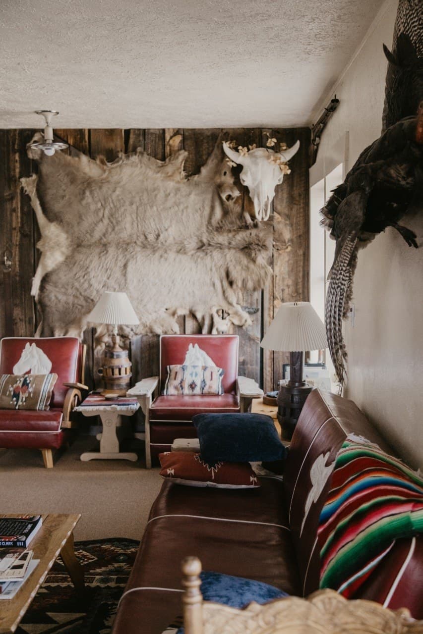Turkey Toe interior — bull skull, hide wall, serape blanket, red leather chairs