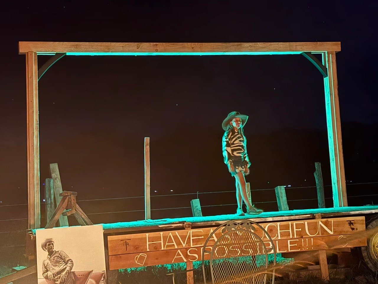 Eva takes the stage for the first time at Turkey Toe — Hay Wagon Stage lit in teal under the Colorado night sky