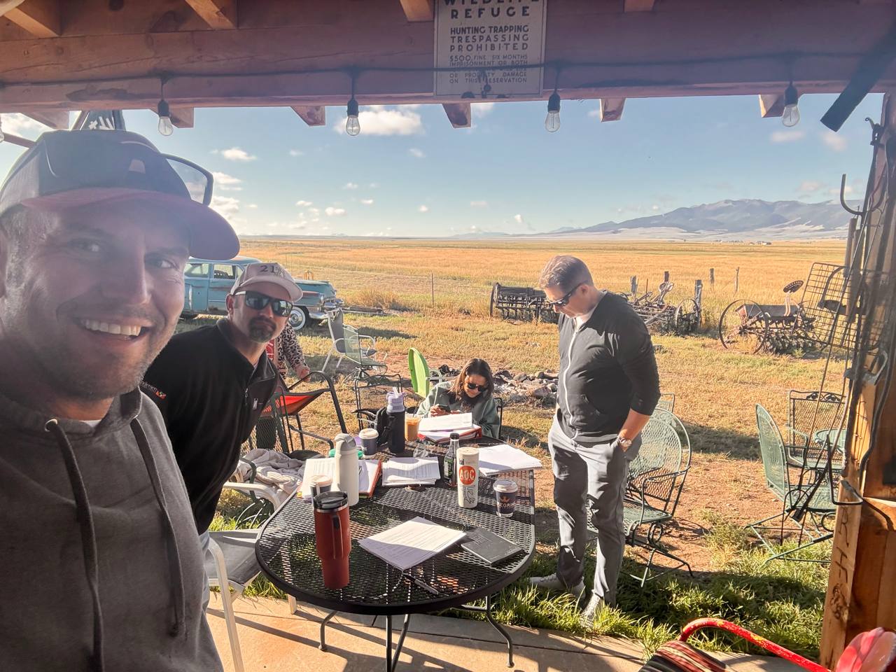 AOC work session at Turkey Toe — documents, coffee, Sangres in background